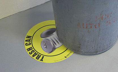 Trash can floor sign under trash can